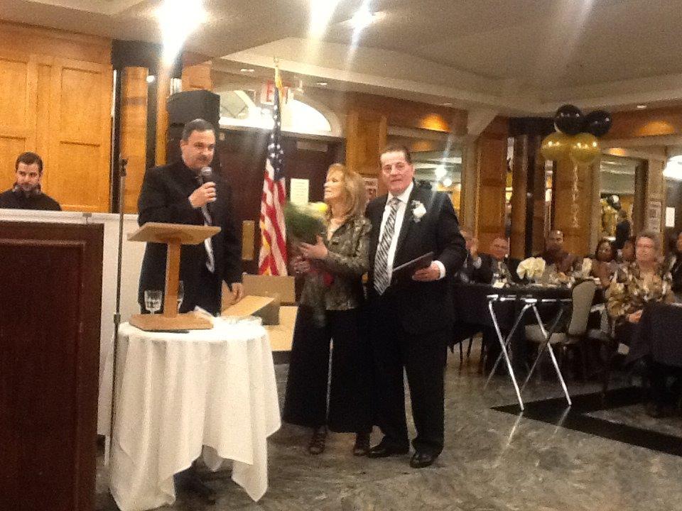 President Ray Beshara Presenting Placque to Tommy and Flowers to Cathy Roma