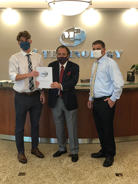 From Left: Ryan Ferris, scholarship winner accepting award from John Pescitelli, President of M3 Technology, as proud father POOM Greg Ferris looks on.